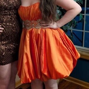 Orange Maggie Sottero formal dress.